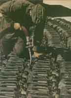 Военнослужащий наполняет канистры горючим для последующей транспортировки в действующие части. Восточный фронт.  Март 1943 г.